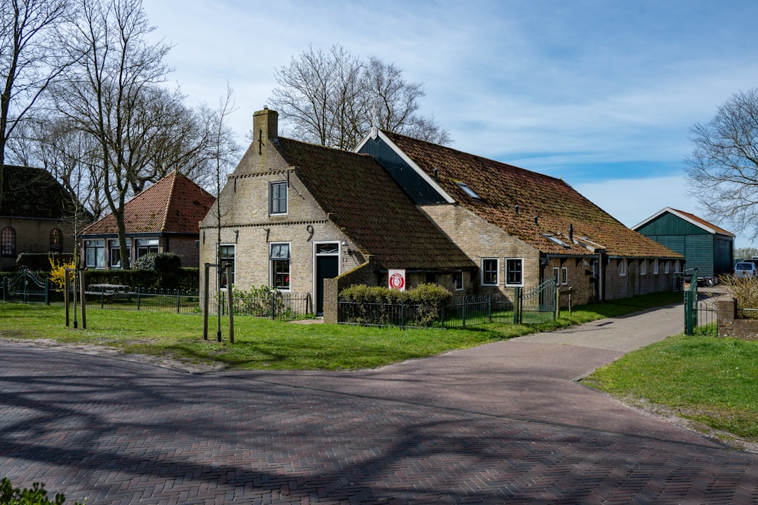 Historic farmhouse and barn in a rural setting.