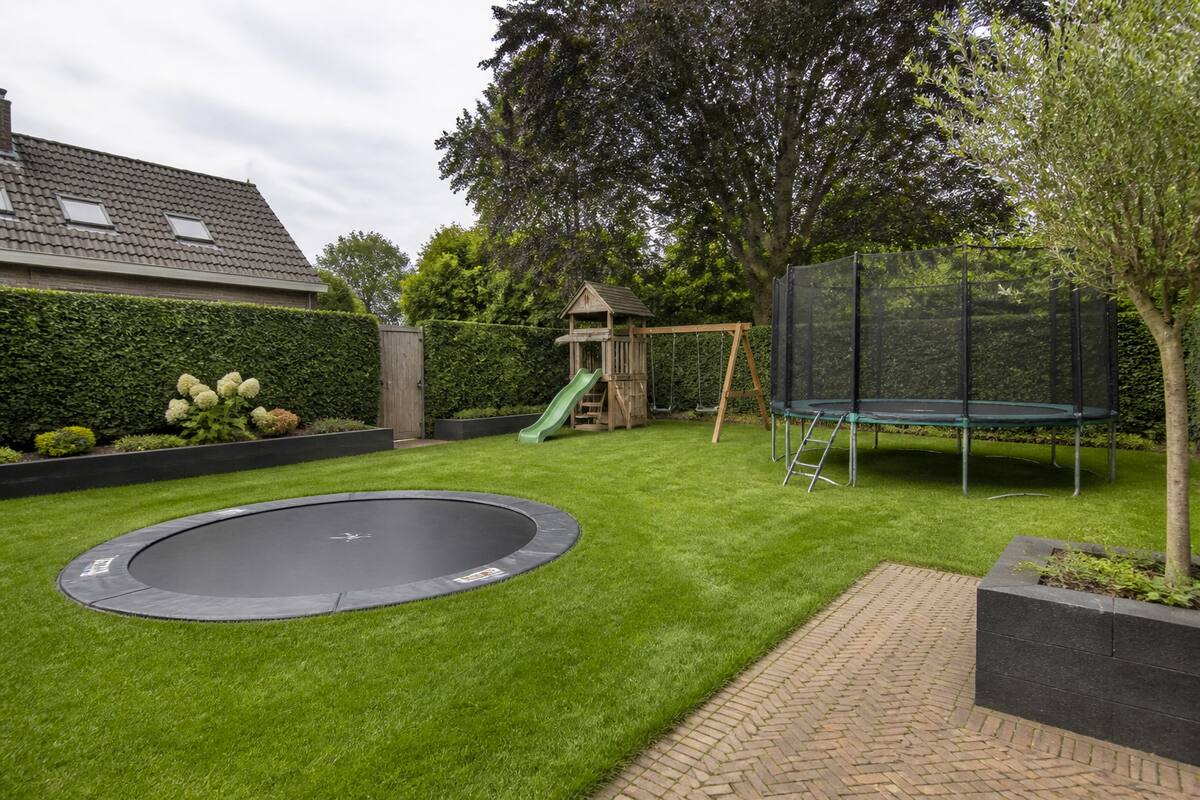 Inground en opbouw trampoline in een achtertuin ter vergelijking